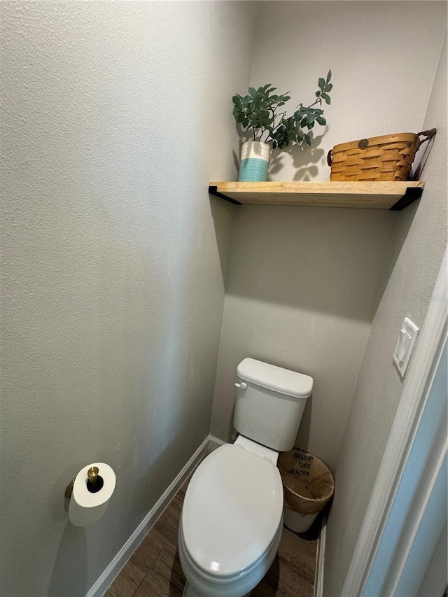 bathroom featuring hardwood / wood-style flooring and toilet