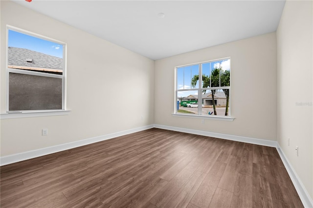 unfurnished room with dark hardwood / wood-style floors