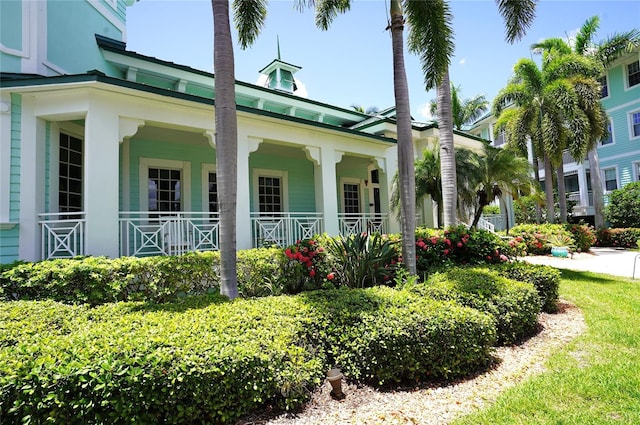 view of side of home with covered porch