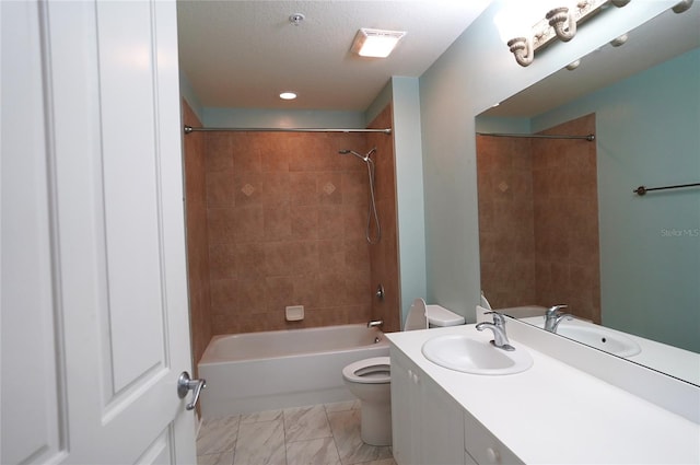 full bathroom with a textured ceiling, tiled shower / bath combo, vanity, and toilet