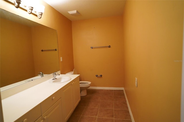 bathroom with tile patterned floors, vanity, and toilet