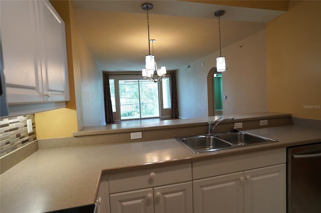 kitchen with white cabinets, sink, decorative light fixtures, backsplash, and dishwasher