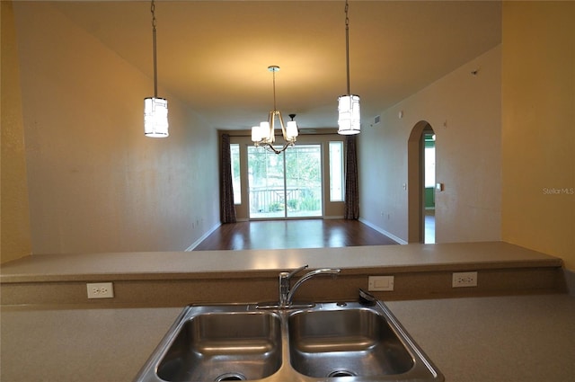 kitchen featuring an inviting chandelier, wood-type flooring, decorative light fixtures, and sink