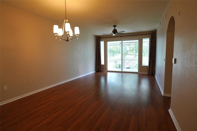 spare room featuring ceiling fan with notable chandelier and dark hardwood / wood-style floors