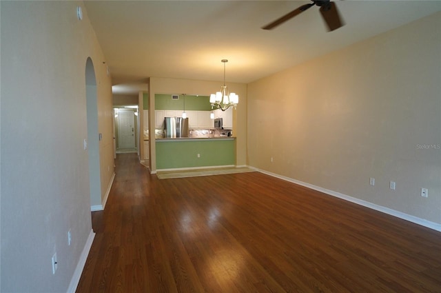 interior space with ceiling fan with notable chandelier and dark hardwood / wood-style floors