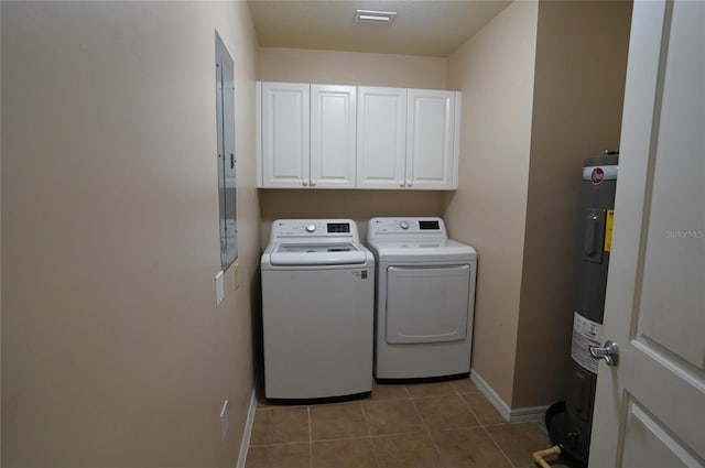 washroom with water heater, light tile patterned flooring, independent washer and dryer, and cabinets