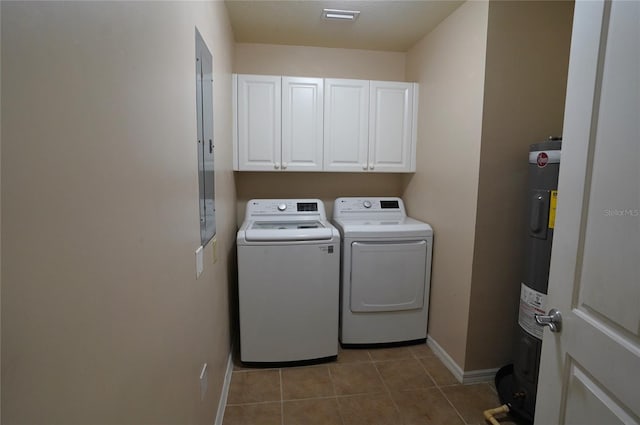 laundry room with light tile patterned flooring, baseboards, water heater, washer and dryer, and cabinet space