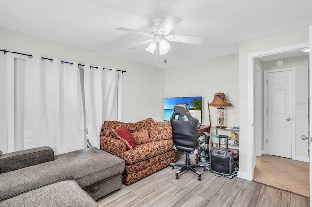 living room featuring light hardwood / wood-style floors and ceiling fan