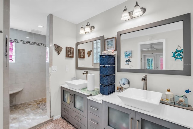 bathroom featuring vanity, a tile shower, and ceiling fan