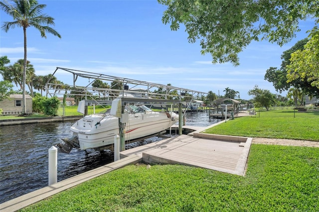 dock area with a yard and a water view