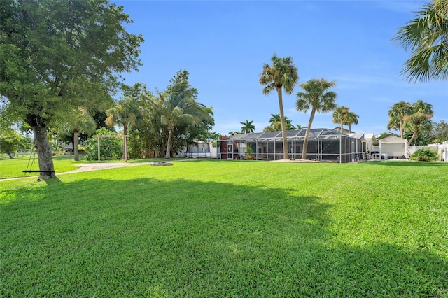 view of yard featuring glass enclosure