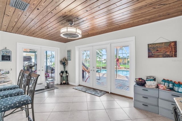 entryway featuring french doors, a healthy amount of sunlight, and wooden ceiling