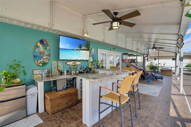 view of patio / terrace with an outdoor bar and ceiling fan