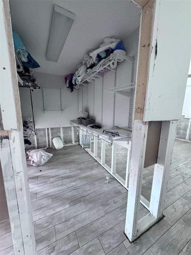 laundry area with light wood-type flooring