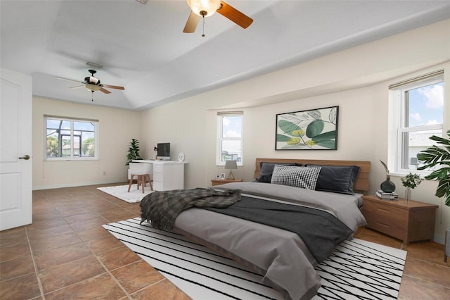 bedroom featuring multiple windows and ceiling fan