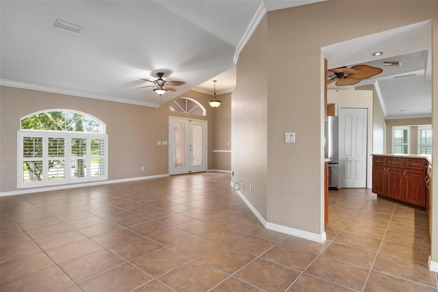 interior space with crown molding, ceiling fan, light tile patterned flooring, and a wealth of natural light