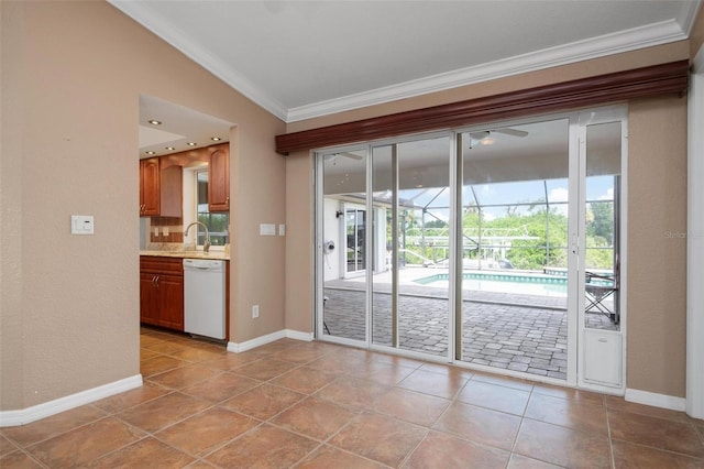 doorway featuring ornamental molding, sink, and light tile patterned flooring