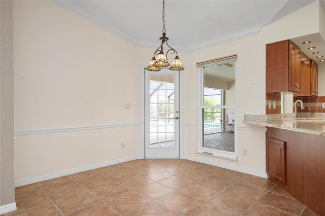 unfurnished dining area with light tile patterned flooring, ornamental molding, a chandelier, and sink