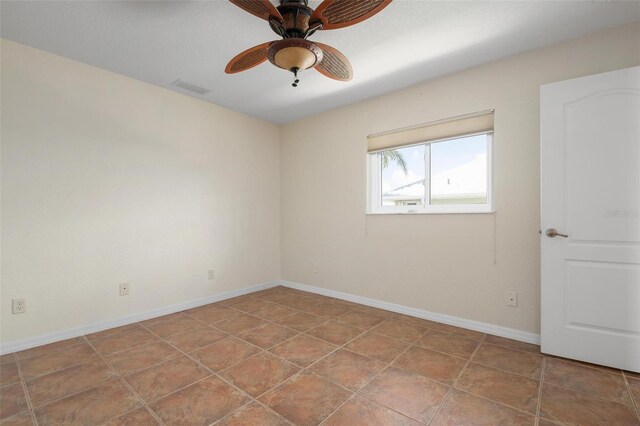 unfurnished room featuring ceiling fan and tile patterned flooring