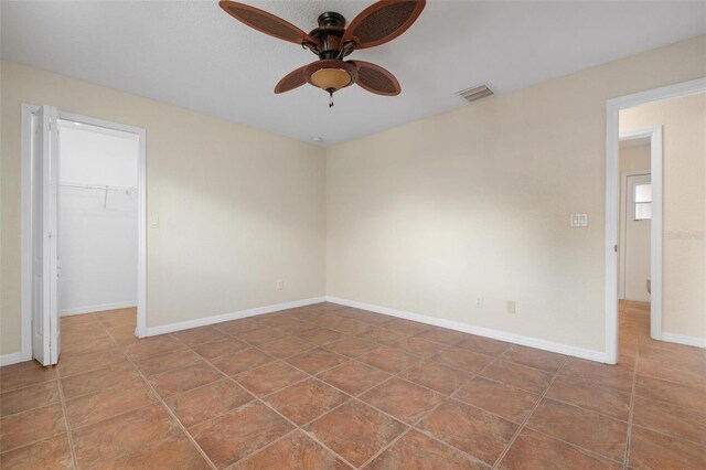 unfurnished room featuring tile patterned floors and ceiling fan