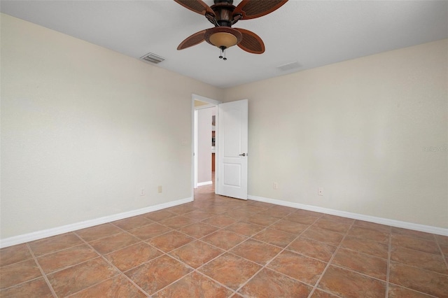 unfurnished room with ceiling fan and tile patterned floors