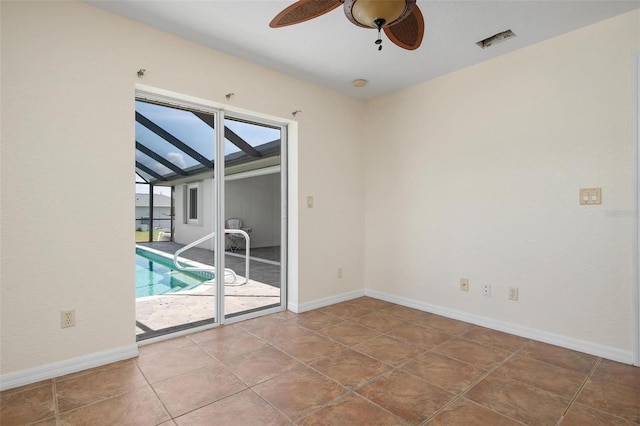 spare room with ceiling fan and tile patterned floors