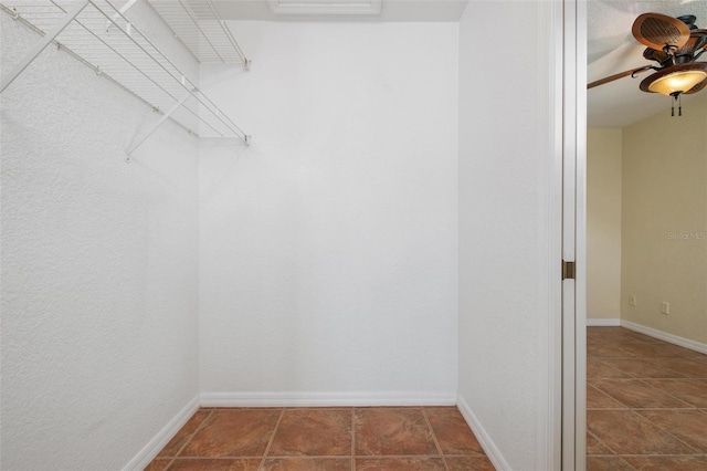 walk in closet featuring ceiling fan