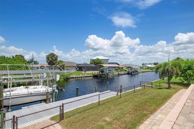 view of dock with a water view and a yard