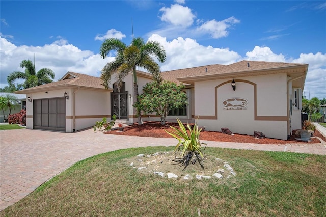 view of front of home with a garage and a front lawn