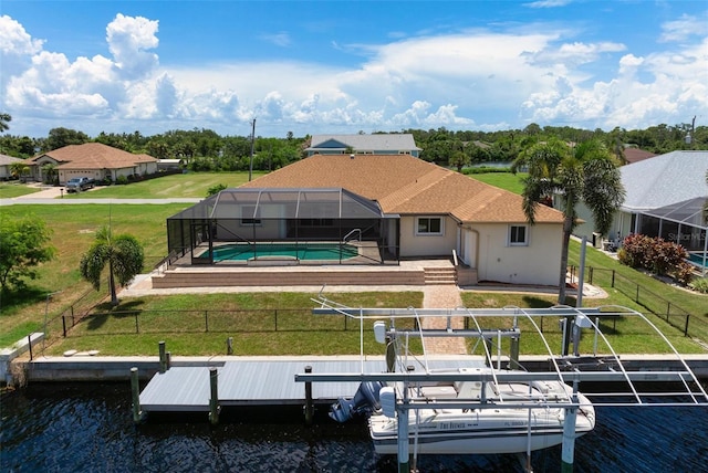 back of property featuring a fenced in pool, a lanai, a lawn, a water view, and a patio area