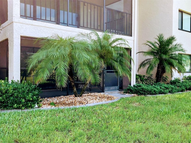 entrance to property with a lawn