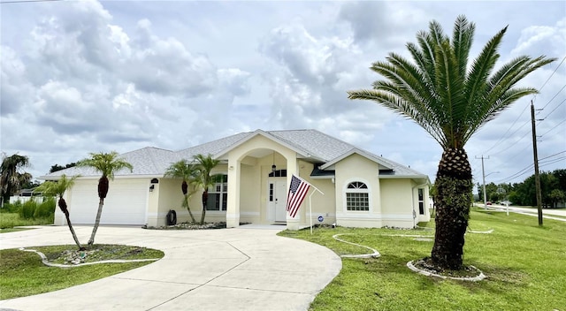 ranch-style house with a garage and a front lawn