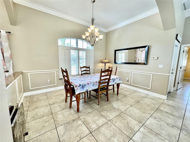 tiled dining room featuring ornamental molding and a chandelier