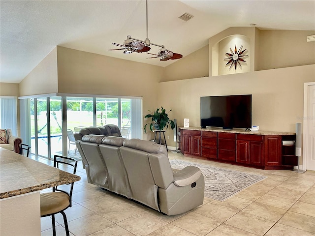 living room with light tile patterned flooring, ceiling fan, and high vaulted ceiling