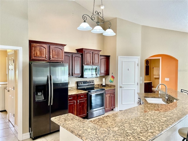 kitchen with sink, light tile patterned floors, appliances with stainless steel finishes, high vaulted ceiling, and decorative light fixtures