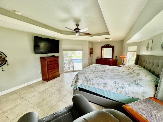 bedroom featuring ceiling fan, a textured ceiling, light tile patterned flooring, access to outside, and a raised ceiling