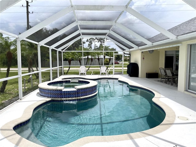 view of pool with a lanai, a patio, and an in ground hot tub