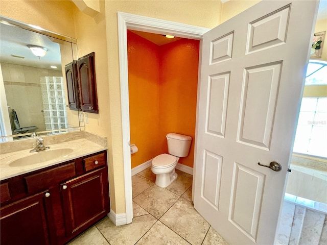 bathroom with vanity, toilet, and tile patterned flooring