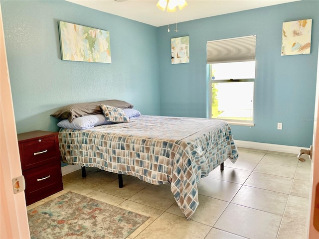 bedroom featuring light tile patterned floors and ceiling fan