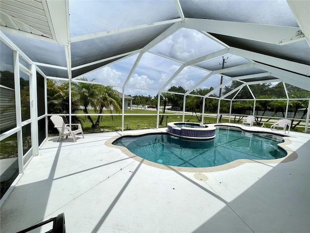 view of swimming pool featuring a yard, an in ground hot tub, a patio, and glass enclosure