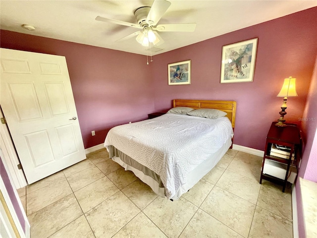 tiled bedroom featuring ceiling fan