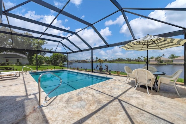 view of pool featuring glass enclosure, a patio area, a water view, and a yard