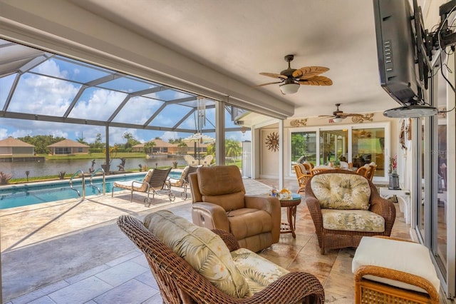 sunroom with a water view, ceiling fan, and a swimming pool