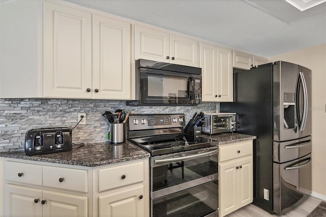 kitchen featuring stainless steel appliances, light hardwood / wood-style floors, dark stone countertops, and tasteful backsplash