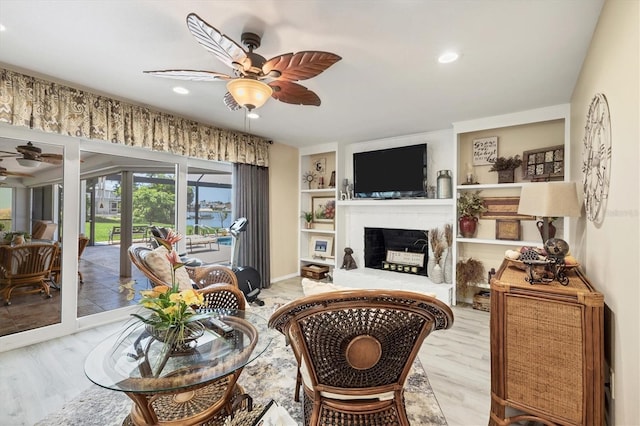 living room featuring ceiling fan and light wood-type flooring