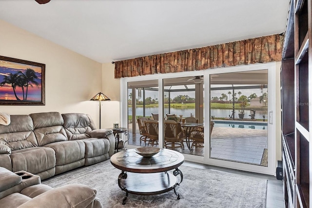 living room with hardwood / wood-style floors and a water view