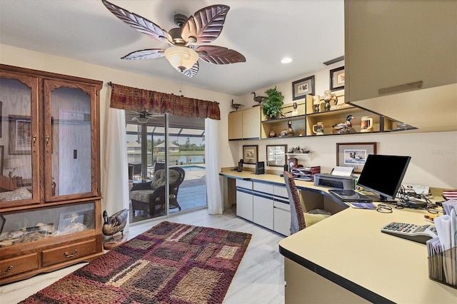 office with light wood-type flooring, built in desk, and ceiling fan