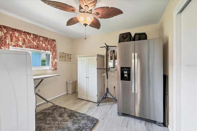 kitchen with light wood-type flooring, ceiling fan, white refrigerator, and stainless steel fridge with ice dispenser