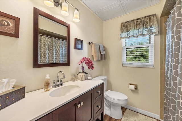 bathroom with hardwood / wood-style floors, vanity, toilet, and a shower with curtain