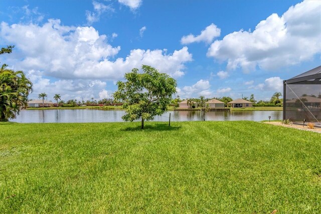 view of yard featuring a water view and a lanai